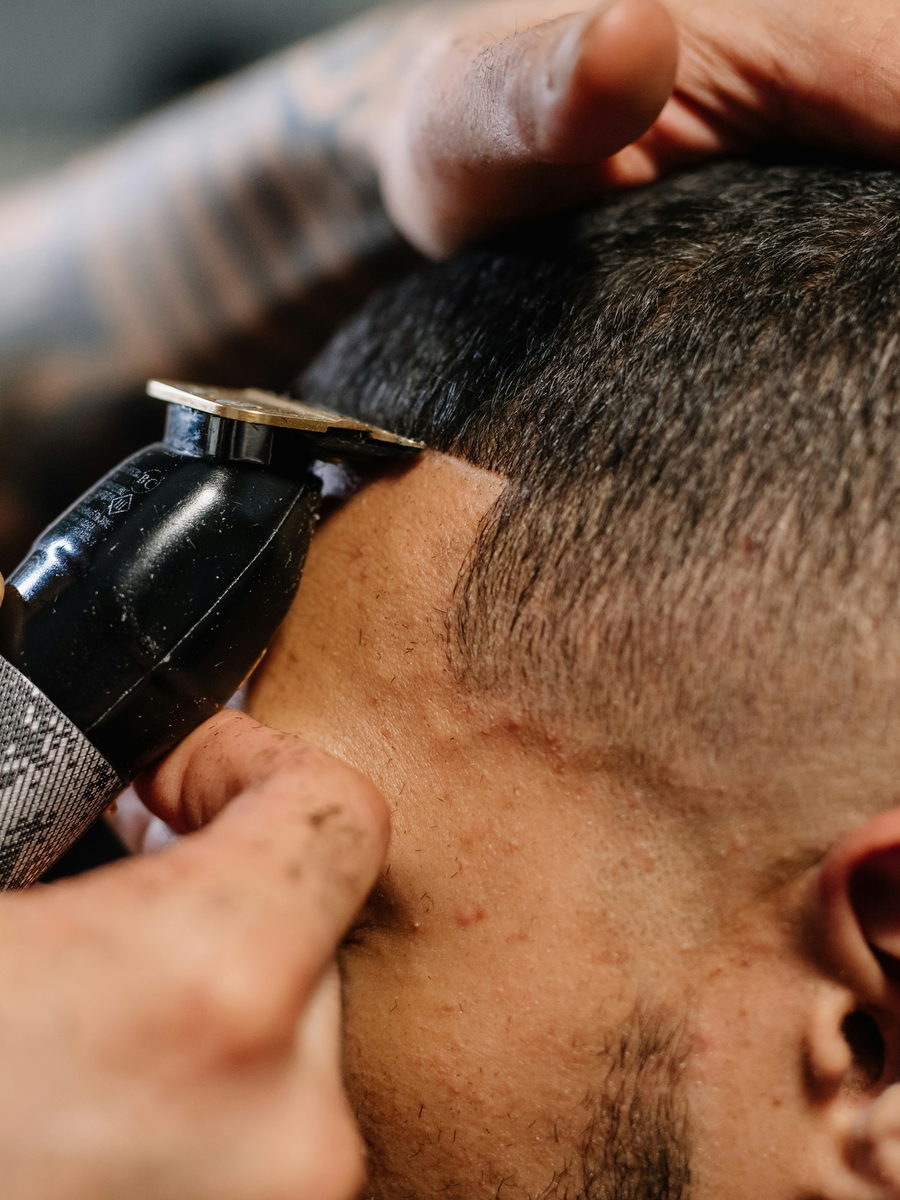 Close-up of a skin fade being lined in with a trimmer